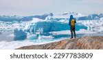 Small photo of Melting icebergs by the coast of Greenland, on a beautiful summer day - Melting of a iceberg and pouring water into the sea - Greenland - Tiniteqilaaq, Sermilik Fjord, East Greenland