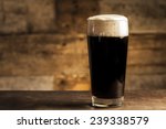 Black Beer On Wooden Background