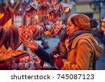Friends Buying Candies On Christmas Market