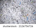 Big stack of shredded documents to protect confidential information, safety is first concept, background, top view, closeup