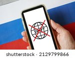 hand with mobile phone with crossed out swift symbol on russian flag background, swift shutdown in Russia banks. War between Ukraine and Russia, Russian aggression, February 2022. Top view