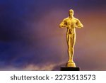 Small photo of Hollywood Golden Oscar Academy award statue on sky background with copy space. Success and victory concept.