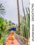Small photo of Girl exploring Majorelle Garden in Marrakech - a two and half acre botanical garden made in the 1920s by the French painter Jacques Majorelle