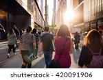 People walking from the work at the street in New York City at sunset time