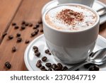Cup with hot cappuccino with foam and cocoa powder, italian breakfast 