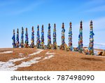 Small photo of Thirteen sarge are ritual pillars in Buryat culture. Wooden poles with a lot of imposed multicolored flaps and ribbons made of fabric. Cape Burkhan. Olkhon Island. Irkutsk region. Russia