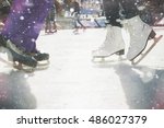 Closeup skating shoes ice skating outdoor at ice rink. Magical glitter of snowy snowflakes and bokeh. Healthy lifestyle and winter sport concept at sports stadium.