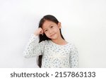 Small photo of Asian young girl put stranglehold on head with looking at camera on white background.