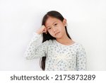 Small photo of Asian young girl put stranglehold on head with looking at camera on white background.