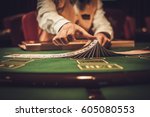 Croupier behind gambling table...