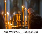 Woman Hand Lighting Candles In...