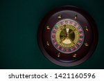 Wooden Roulette Drum on Green Casino Felt Table, Border BAckground, Top View.