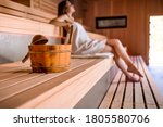 Young woman relaxing in spa using sauna
