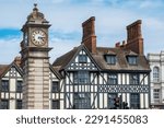 Small photo of Victorian clock tower next to the half-timbered buildings in Clapham district. London, England