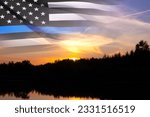Small photo of Thin Blue Line. American flag with police blue line on a background of sunset. Support of police and law enforcement. National Law Enforcement Appreciation Day