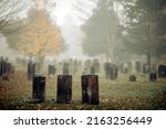 Three gravestones standing in a ...