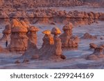 Small photo of The rays of the setting sun illuminate goblins in Goblin Valley State Park, Utah.