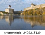 Small photo of Ancient Herman's castle and Ivangorod fortress on the border river Narva on a sunny October day. Border between Russia and Estonia