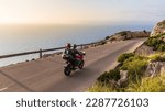 Small photo of Motorbikes on the road on the seashore.