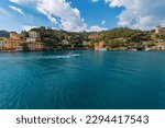 Bay and port of the famous village of Portofino, luxury tourist resort in Genoa Province, Liguria, Italy, Europe. Colorful houses, Mediterranean sea (Ligurian sea).
