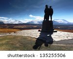 The Commando memorial monument in silhouette with the snow covered Ben Nevis mountain range in the distance. Located 1 mile north of the village Spean bridge near Fort William, Scotland.