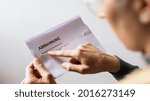 Small photo of Amahnung, Sehr geehrte dame, sehr geehrter Herr (German for: final notice, Dear Madam, dear Sir) Hand Holding and showing a Receiving a Final Notice Envelope concept of lawyer or business