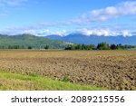 Small photo of Wide, landscape view of tilled Spring acreages found on the Sumas Prairie on the eastern end of the Fraser Valley in southern BC, Canada.