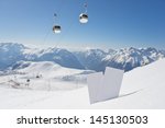 Small photo of Lift pass card in snow with blurred ski-lift and mountain range. Concept to illustrate winter sport admission fee
