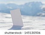 Small photo of Ski lift pass stuck in snow ready for your design. Concept to illustrate winter sport admission fee