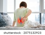 Lumbar intervertebral spine hernia, woman with back pain at home, spinal disc disease, health problems concept