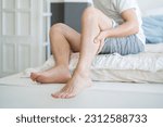 The man's calf muscle cramped, massage of male leg at home, painful area highlighted in red