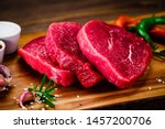 Fresh raw beef steaks on cutting board
