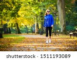Middle-aged woman walking in city park