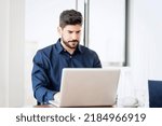 Small photo of Careworn businessman wearing shirt and using laptop while sitting at desk and working.