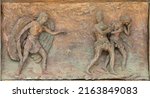 Small photo of MONOPOLI, ITALY - MARCH 6, 2022: The bronze relief Expulsion of Adam and Eve from Paradise the on the gate of church Chiesa di Sacro Cuore by Wolfgang Stempfele from year 2002.