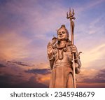 Small photo of The huge Shiva statue Mangal Mahadev is a 33 m art piece in Ganga talao temple on the blue evening sunset sky, Mauritius island.