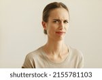 Small photo of Portrait of squeamish woman with blond hair posing next to color background