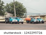 Small photo of trash truck or dump-truck municipality sanitation salubrity truck fleet of city vehicles for urban garbage collector service with retro car transportation for sanitation services to city residents