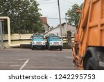 Small photo of trash truck or dump-truck municipality sanitation salubrity truck fleet of city vehicles for urban garbage collector service with retro car transportation for sanitation services to city residents