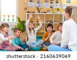 Active preschool Children Interacting with their Teacher. Teacher-child relationships – Early Learning.  Healthy Learning Environment