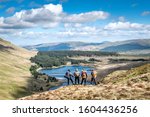Small photo of SNOWDONIA, WALES- MAY, 2019: A gaggle of vagabond hikers overlooking a beautiful vista in Snowdonia National Park unknowing of what the forest below has in store for them that evening.