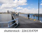 Small photo of St. Kilda, Melbourne, Victoria, Australia - 06 Apr 2014: People walking on St Kilda Pier on a sunny autumn day.
