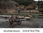 Small photo of Old wooden handbarrow in front of sloped-roof and thatched-roof houses at Hida Folk Village, Takayama, Japan. Here is famous of similarity preserved village as Shirakawago.