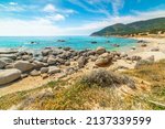 Small photo of Rocks and sand in Porto Sa Ruxi beach in springtime. Sardinia, Italy