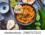 Homemade vegan Harissa carrot and lentil spread or dip with flatbread and cucumber