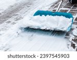 Cleaning snow from sidewalk and using snow shovel