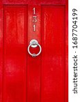 Small photo of House number 131 on a red wooden front door