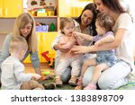 Small photo of Group of mothers with nursery babies at playgroup