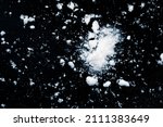 Small photo of Snow wrecks, scattered on black background.