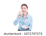 Beautiful asian woman eating yogurt with fruits over white background